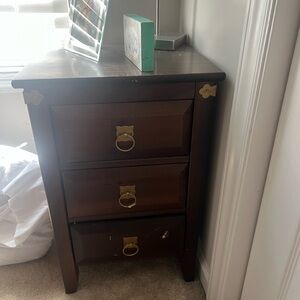 Dark Wood Three-Drawer Nightstand with Gold Accents